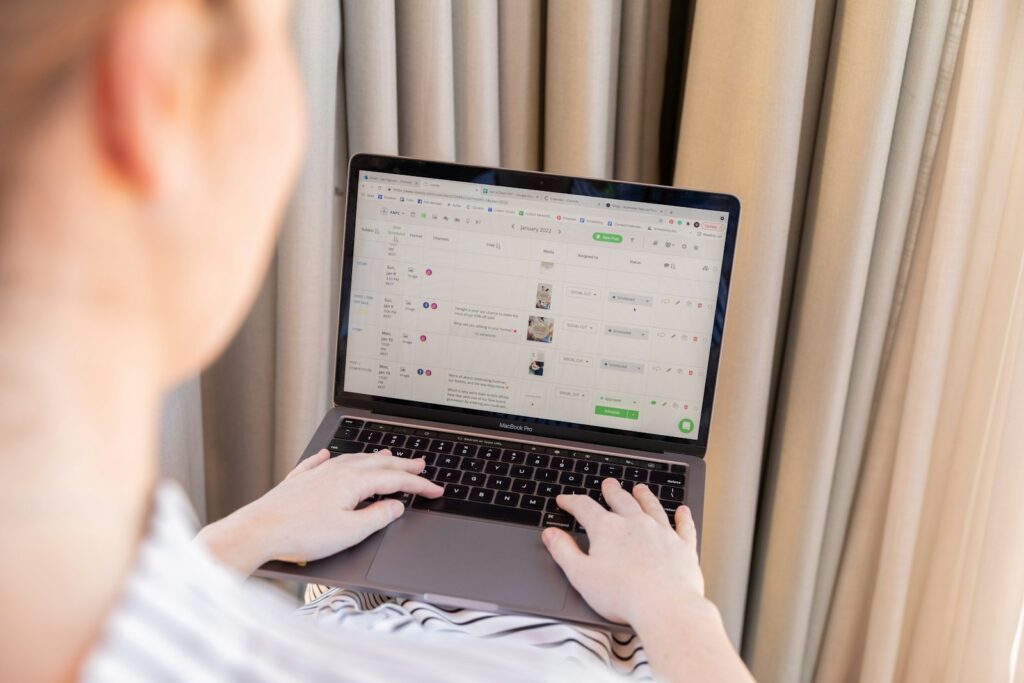 a person sitting in front of a laptop computer